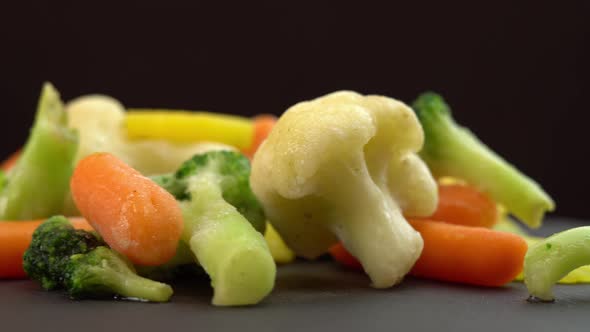 Fresh Frozen Vegetables Rotating on Black Background Healthy Food or Diet Food for Vegetarians and