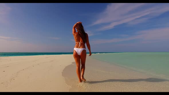 One girl happy and smiling on perfect island beach journey by blue green water with white sand backg