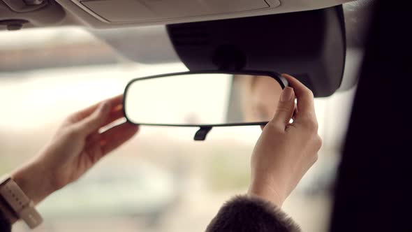 Woman Driver Adjusts Mirror In Car. Automobile Transport Independent Woman Driving. Safety Adjust.