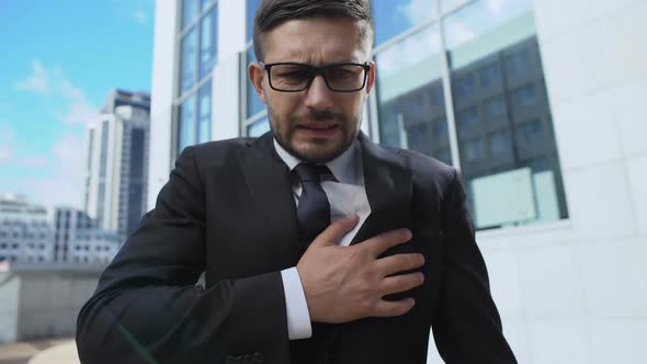 Worried Man Taking Pill Feeling Sudden Pain in Chest, Suffering From Tachycardia