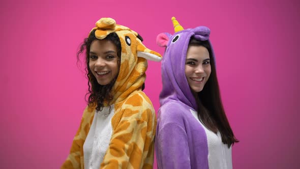 Two Women in Funny Pajamas Standing Back to Each Other With Hands Crossed, Joy