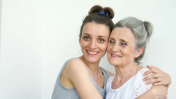 Happy Senior Mother is Hugging Her Adult Daughter the Women are Laughing Together Sincere Family of