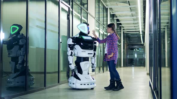 Teenage Girl Is Touching a Humanlike Robot