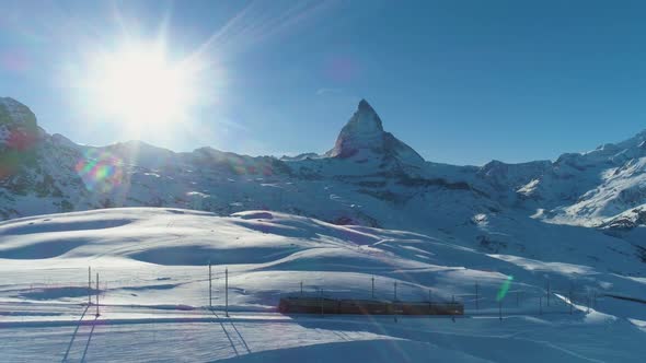 Matterhorn Mountain and Cog Railway Train in Sunny Winter Day. Swiss Alps. Switzerland. Aerial View