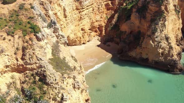 Paradisiac secluded beach surround by steep cliffs, Atlantic ocean , Algarve