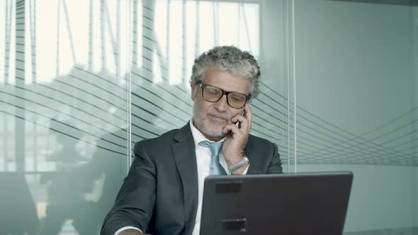 Serious Mature Business Professional Wearing Suit and Glasses