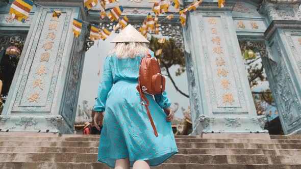 A girl walks with a Vietnamese hat on Ba Na Hills, VietnamA girl walks with a Vietnamese hat on Ba N