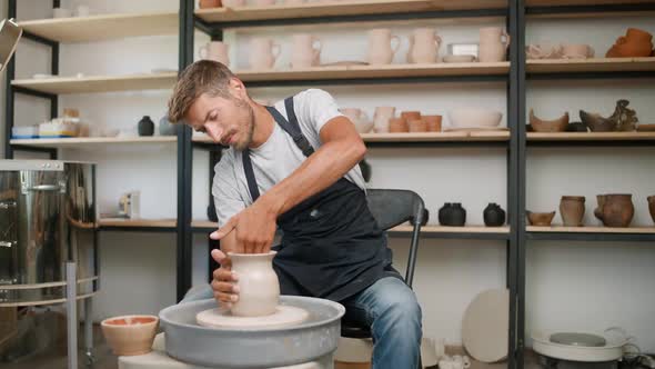 Man Ceramist Makes a Pitcher Out of Clay Production of Handmade Tableware Pottery Workshop