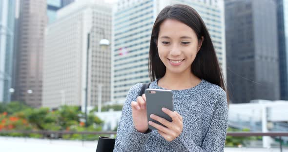 Young woman use of smart phone in city