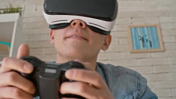 Young Man Gaming in VR Headset