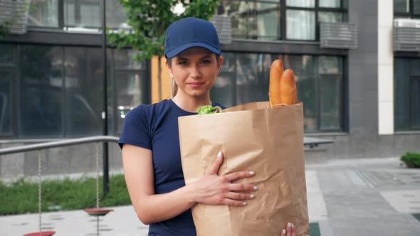 Portrait Smiling Food Delivery Woman Courier Holds Paper Bag with Groceries