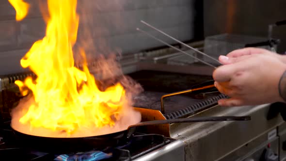 Cook Frying Duck Breast Meat with Open Flame