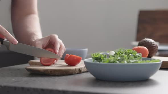 Slow Motion Man Make Salad with Kale Mozzarella Avocado and Cherry Tomatoes Cut Cherry Tomatoes