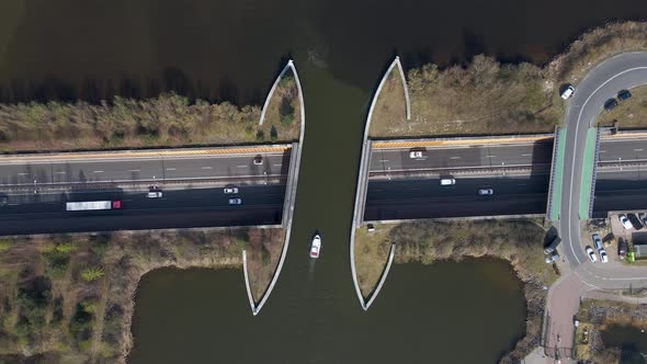 Topdown view Veluwemeer Aqueduct, boat sailing above Traffic in highway, The Netherlands