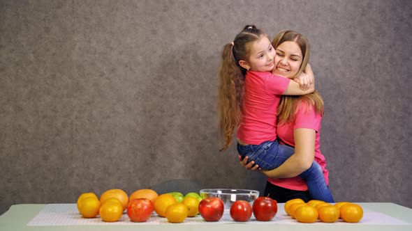 Having great time with mother. Young mother having fun on kitchen with daughter