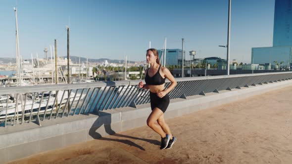 Sportswoman Jogging Near Port in Morning