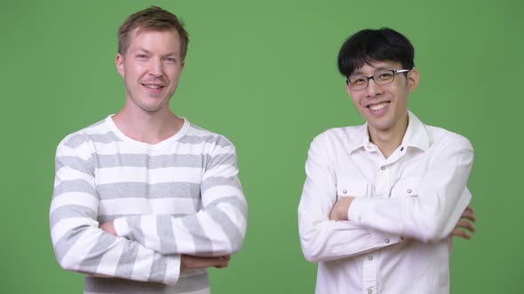 Two Happy Young Multi-ethnic Businessmen Together with Arms Crossed