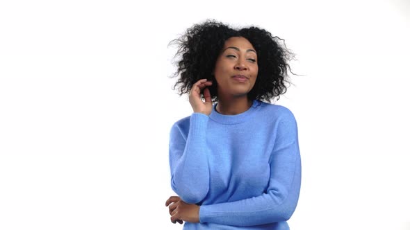 Young African Woman with Afro Hairstyle Looking to Camera Flirting