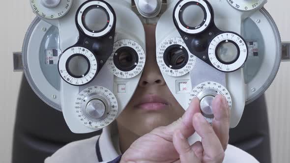 Little Boy's Eye Examination at Optometrist Ophthalmologist Using Phoropter Close Up