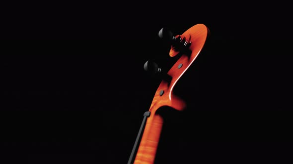 Carved head of Cello or Fiddle on black background isolated