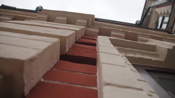 Old Building Made of White and Red Bricks in City District