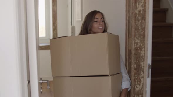 Beautiful Woman Putting Two Boxes on Another One