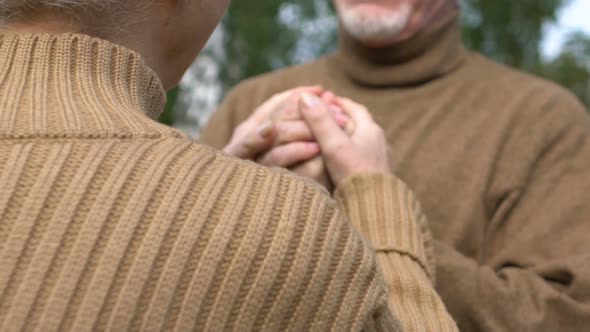 Mature Woman Hugging Hands of Her Husband, Love and Care, Togetherness, Close-Up