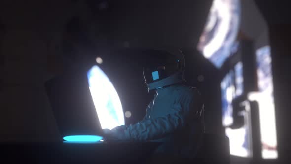 Astronaut Works on His Laptop in Futuristic Spaceship