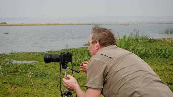 Photographer Takes Video Of Wildlife Of Africa On Camera Standing On Tripod