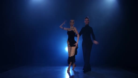 Rumba Dancing Pair of Professional Elegant Dancers in Smoky Studio