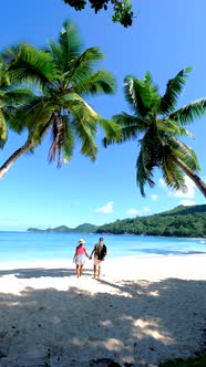 Anse Takamaka Beach Mahe Seychelles Tropical Beach with Palm Trees and a Blue Ocean Couple Man and