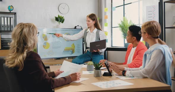 Woman Explaining Presentation of Economic Growth of Production for Attantive motivated