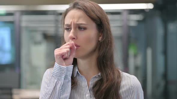 Portrait of Young Businesswoman Coughing