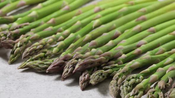  Fresh raw organic green mini asparagus in a row close up