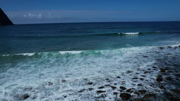 Surfer surfing a wave in the Northernmost best surf spot at unstad in Lofoten Norway