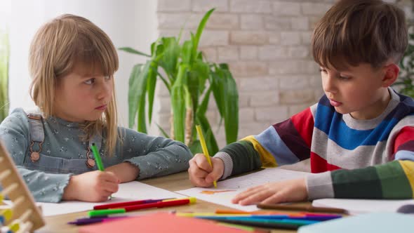 Video of brother and sister doing homework together at home. Shot with RED helium camera in 8K