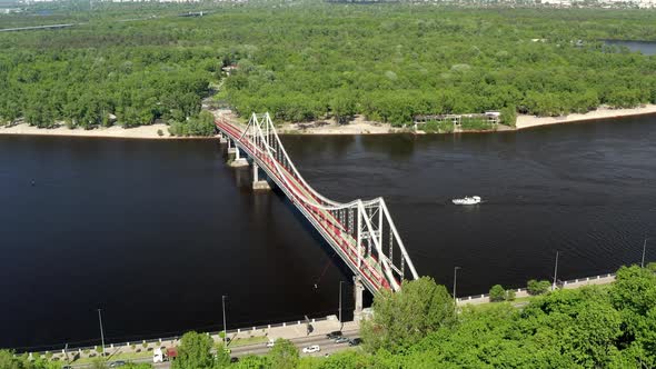 Summer flight over the footbridge in Kiev. Bridge over the Dnieper.