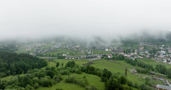 AERIAL - The town of Bakuriani, Georgia in the fog, mist, forward shot