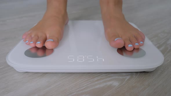 Female Bare Feet Stepping on Digital Floor Scales  Woman Weighing Herself