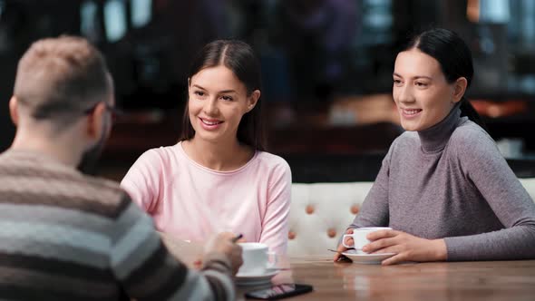 Group Friendly People Talking at Informal Meeting Shaking Hands in Public Cafe