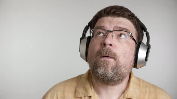 Portrait of bearded 48 years old caucasian man enjoy listen to romantic slow musi