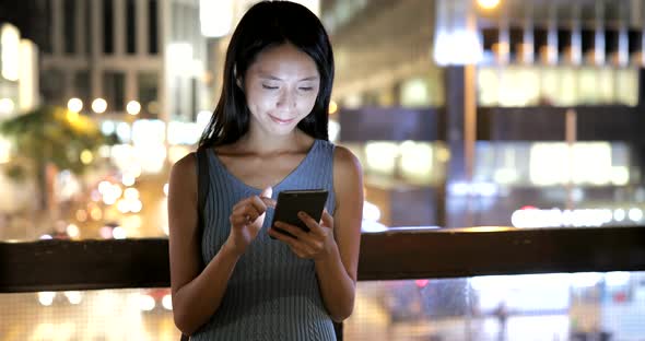 Woman Looking at Mobile Phone in Hong Kong City