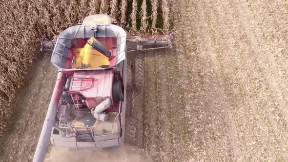 Close view of Combine Harvester in action, harvesting corn in the field in Southeast Michigan - aeri