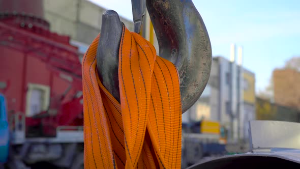 In the Frame Is a Huge Crane Hook. Construction Site, Crane on Huge Belts, Pulls the Load.