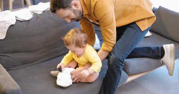 Father Wearing His Little Son at Home