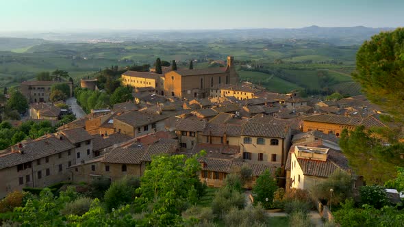 San Gimignano, Tuscany, Italy. Panning Shot of San Gimignano Medieval Town Roofs in Sunset Lights