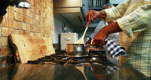 Senior couple preparing food in kitchen