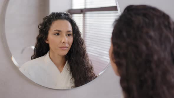 Closeup Serious Pensive Young Hispanic Woman Looking in Mirror in Bathroom Contemplating Future Cute