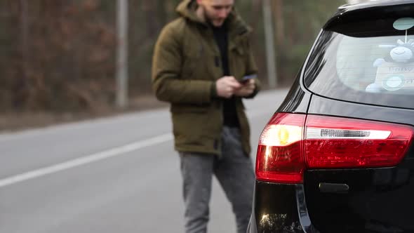 A man calls a tow truck due to a car breakdown