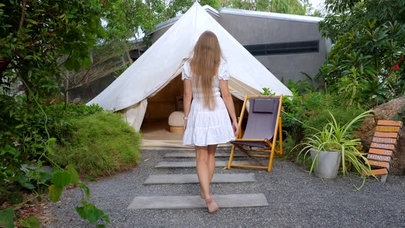 Young Beautiful Slim Woman in Short White Dress Walking Barefoot In Tourist Tent